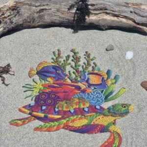 Turtle-shaped wooden jigsaw puzzle with tropical fish and coral on a sandy beach