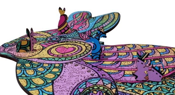 Rabbit-shaped whimsy puzzle pieces shown on a patterned rabbit shaped wooden jigsaw puzzle